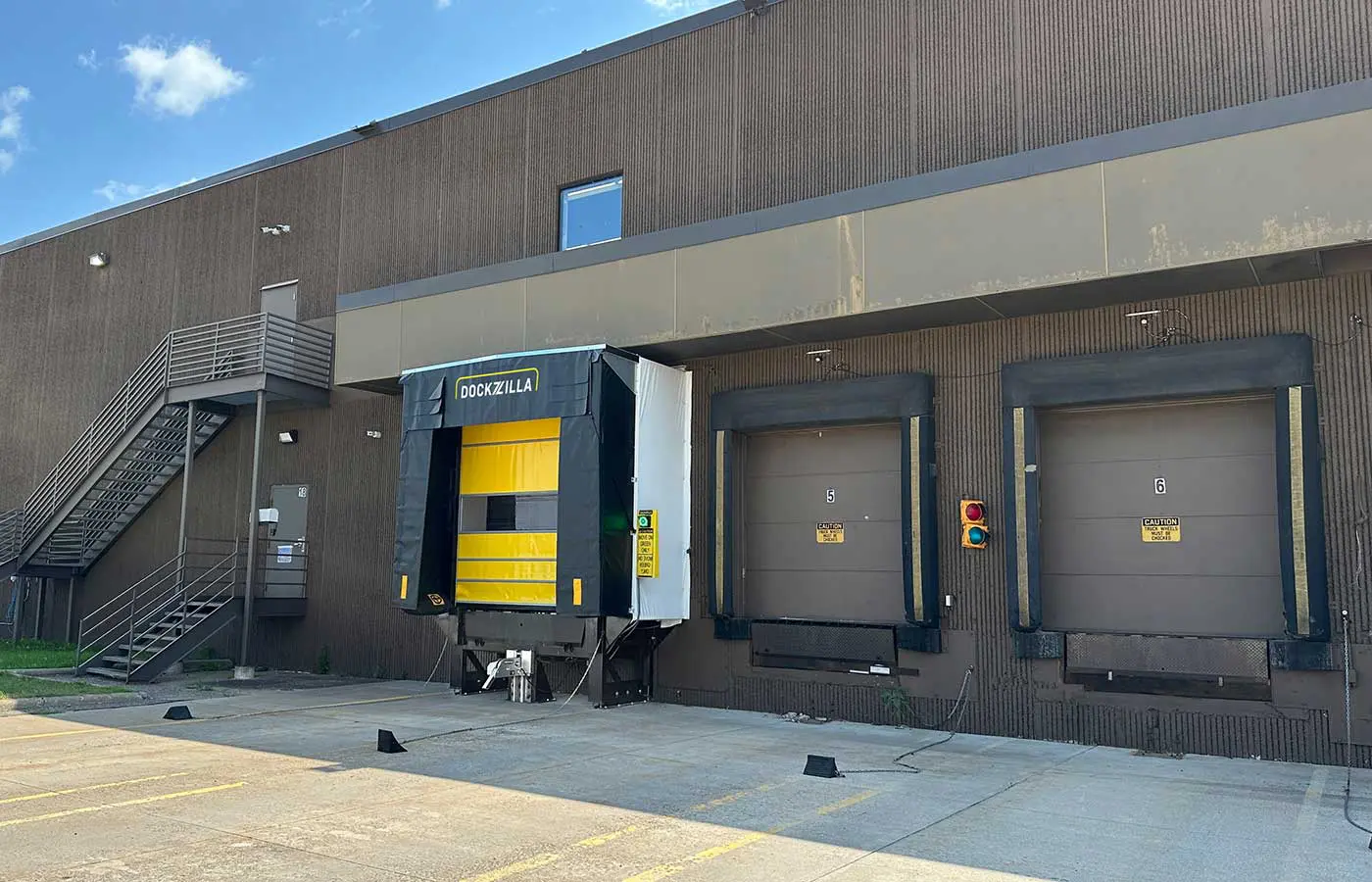 Dockzilla Dock House Exterior Loading Dock Leveler Dockzilla Dock House exterior dock leveler next to pit-style dock leveler