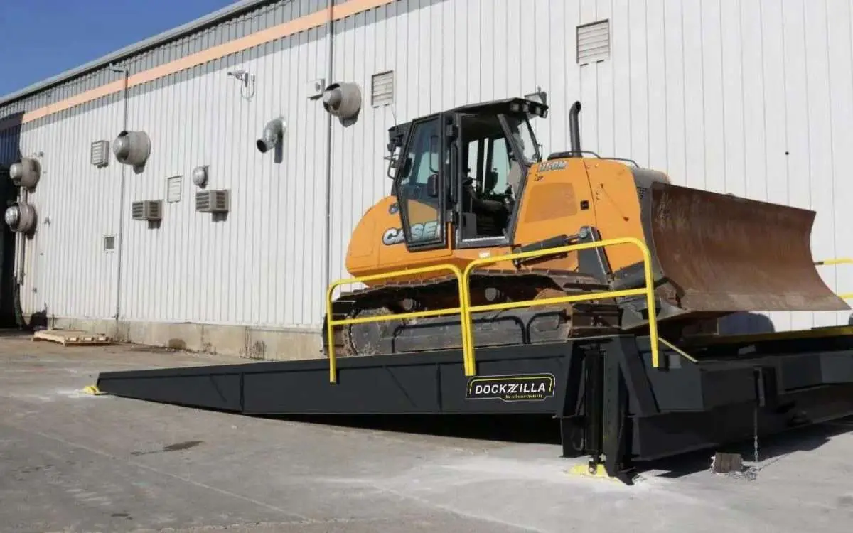 Dockzilla High-Capacity Implement Loading Dock A Dockzilla high-capacity implement loading dock with a bulldozer, designed for loading and off-loading equipment up to 85,000 lbs.