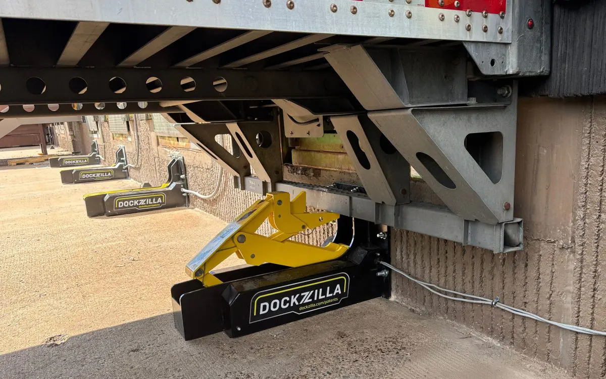 Dockzilla Vehicle Restraint Engaged Dockzilla Universal Vehicle Restraint engaged at loading dock position with trailer in place